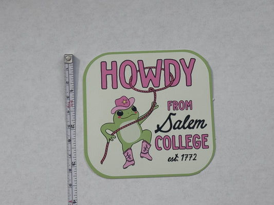 A die-cut sticker featuring a cartoon green frog wearing pink boots and a pink cowboy hat, holding a lasso. The sticker reads 'HOWDY FROM Salem COLLEGE est.
